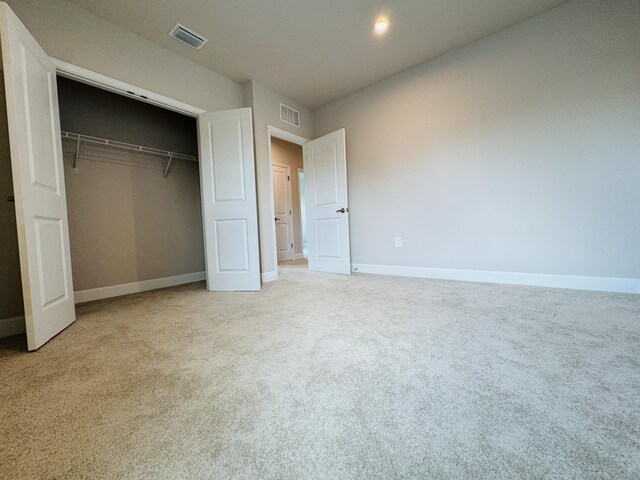 163 SW Pomeroy St, Stuart, FL 34997 - unfurnished bedroom featuring carpet, baseboards, and a closet