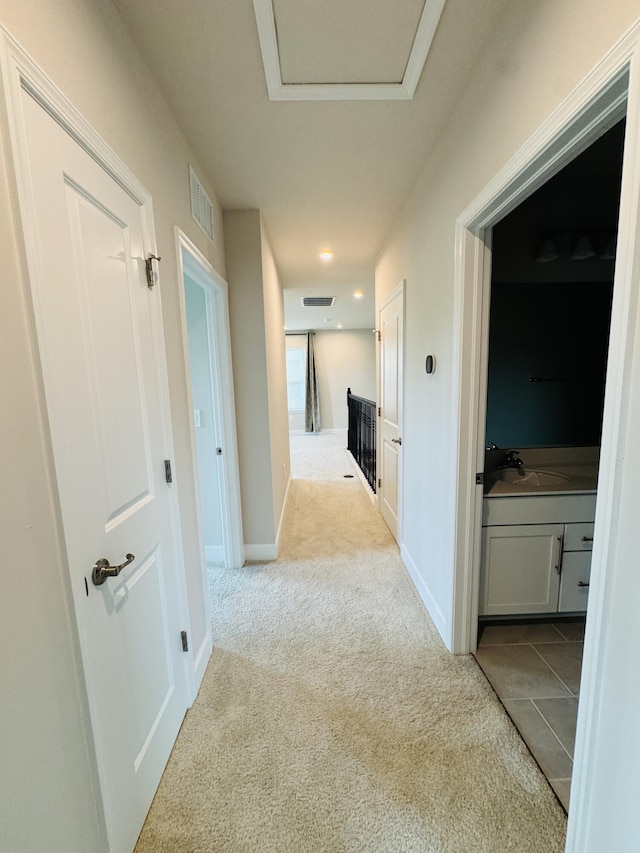 163 SW Pomeroy St, Stuart, FL 34997 - hall with carpet flooring, a sink, attic access, and baseboards