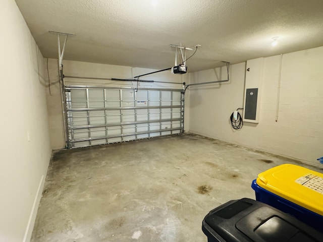 163 SW Pomeroy St, Stuart, FL 34997 - garage featuring electric panel, a garage door opener, and baseboards
