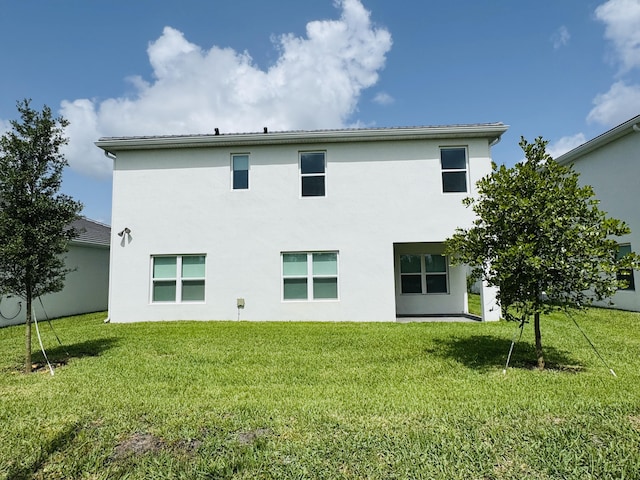 163 SW Pomeroy St, Stuart, FL 34997 - back of property featuring stucco siding and a yard