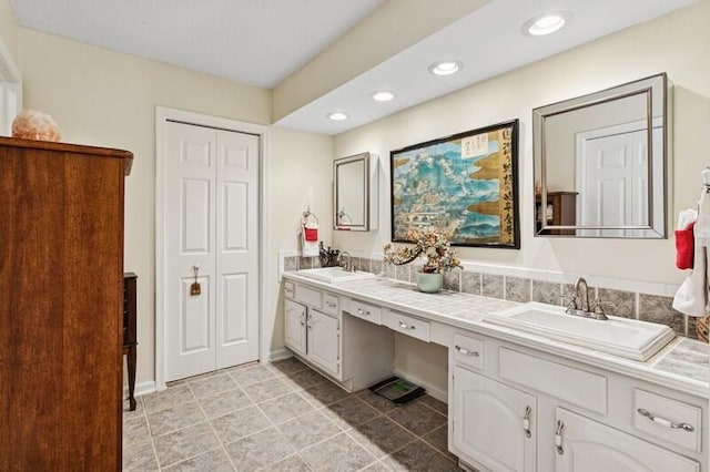 7 Atrium Cir Unit D, Atlantis, FL 33462 - full bathroom with double vanity, recessed lighting, tile patterned floors, and a closet