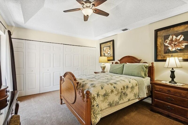 7 Atrium Cir Unit D, Atlantis, FL 33462 - carpeted bedroom featuring a closet, a ceiling fan, a raised ceiling, and a textured ceiling