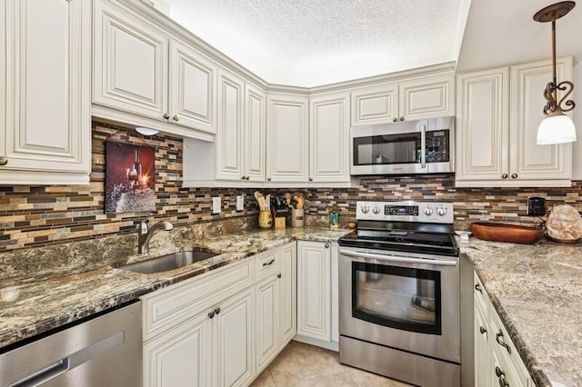 7 Atrium Cir Unit D, Atlantis, FL 33462 - kitchen with stainless steel appliances, a textured ceiling, backsplash, light stone countertops, and decorative light fixtures