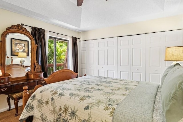 7 Atrium Cir Unit D, Atlantis, FL 33462 - bedroom featuring a closet, carpet flooring, a ceiling fan, and a textured ceiling