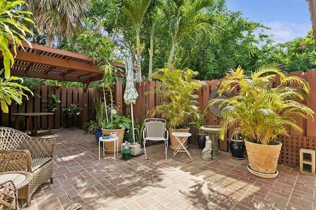 7 Atrium Cir Unit D, Atlantis, FL 33462 - fenced backyard featuring a pergola and a patio area