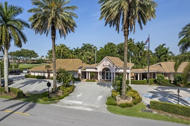 7 Atrium Cir Unit D, Atlantis, FL 33462 - view of front facade featuring uncovered parking