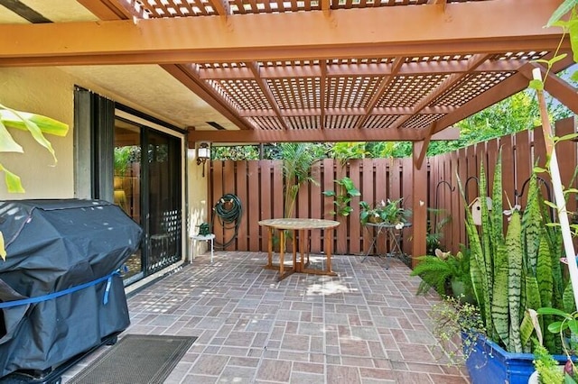 7 Atrium Cir Unit D, Atlantis, FL 33462 - fenced backyard with a pergola, a grill, and a patio