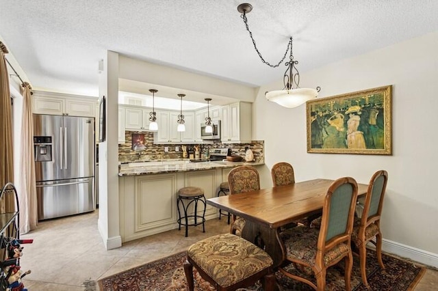 7 Atrium Cir Unit D, Atlantis, FL 33462 - dining space featuring a textured ceiling and light tile patterned flooring