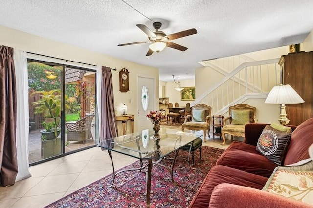 7 Atrium Cir Unit D, Atlantis, FL 33462 - tiled living room with stairway, a ceiling fan, and a textured ceiling