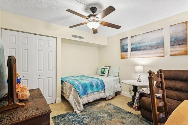 7 Atrium Cir Unit D, Atlantis, FL 33462 - bedroom with a closet, a textured ceiling, and ceiling fan