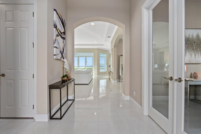 8650 SW Felicita Way, Port Saint Lucie, FL 34987 - hallway featuring arched walkways, french doors, and recessed lighting