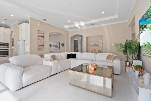 8650 SW Felicita Way, Port Saint Lucie, FL 34987 - living area featuring arched walkways, ornamental molding, light tile patterned floors, recessed lighting, and a raised ceiling