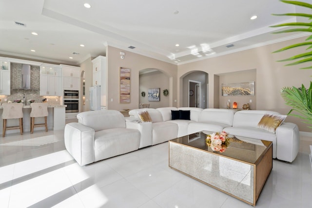 8650 SW Felicita Way, Port Saint Lucie, FL 34987 - living area with arched walkways, crown molding, recessed lighting, and light tile patterned floors