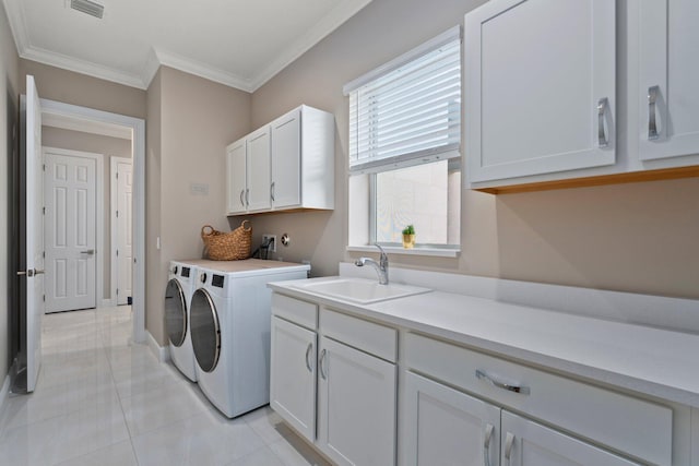 8650 SW Felicita Way, Port Saint Lucie, FL 34987 - laundry room featuring cabinet space, crown molding, independent washer and dryer, and light tile patterned floors