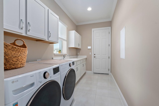 8650 SW Felicita Way, Port Saint Lucie, FL 34987 - laundry room featuring washer and clothes dryer, cabinet space, crown molding, and light tile patterned flooring