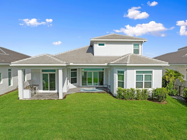 8650 SW Felicita Way, Port Saint Lucie, FL 34987 - rear view of house with an outdoor kitchen, a tiled roof, and stucco siding