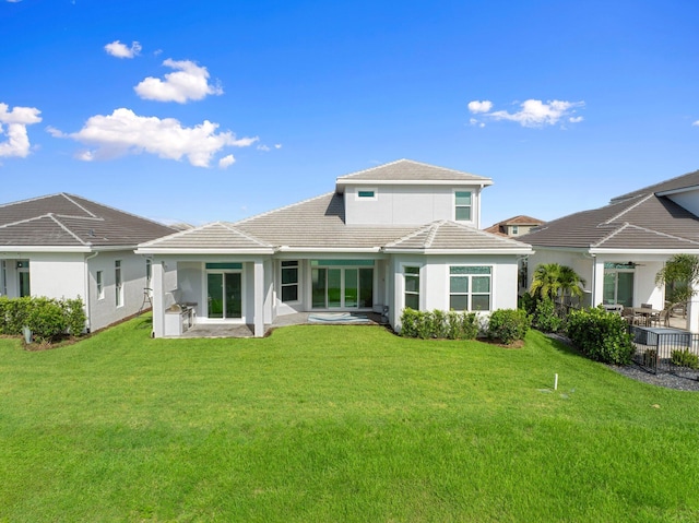 8650 SW Felicita Way, Port Saint Lucie, FL 34987 - rear view of house with a tile roof, a patio area, stucco siding, and a yard