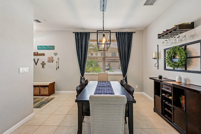 9425 SW Purple Martin Way, Stuart, FL 34997 - dining space featuring light tile patterned floors, a textured ceiling, and a chandelier
