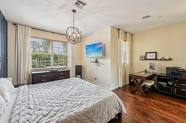 9425 SW Purple Martin Way, Stuart, FL 34997 - bedroom featuring dark wood finished floors and a chandelier
