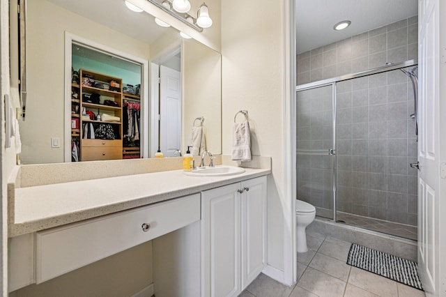 9425 SW Purple Martin Way, Stuart, FL 34997 - full bath featuring vanity, a spacious closet, tile patterned flooring, a stall shower, and recessed lighting