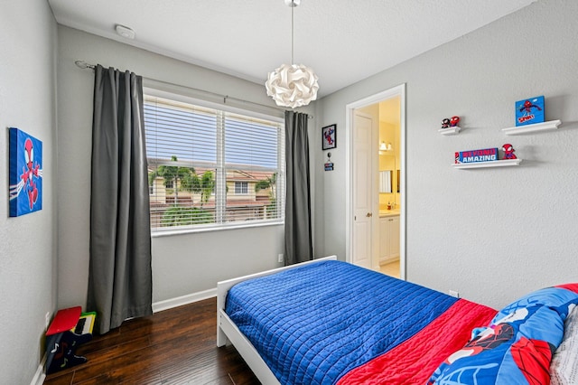 9425 SW Purple Martin Way, Stuart, FL 34997 - bedroom with hardwood / wood-style flooring, a chandelier, and connected bathroom