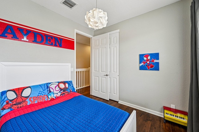 9425 SW Purple Martin Way, Stuart, FL 34997 - bedroom featuring a chandelier and wood finished floors