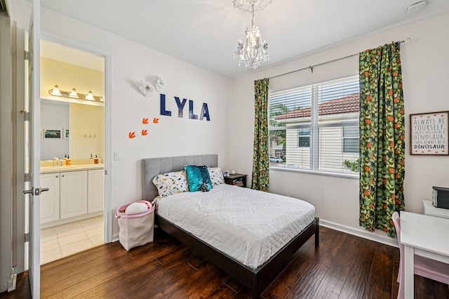 9425 SW Purple Martin Way, Stuart, FL 34997 - bedroom featuring a chandelier, wood finished floors, and ensuite bath