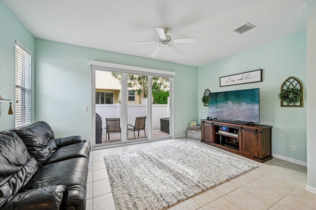 9425 SW Purple Martin Way, Stuart, FL 34997 - tiled living room featuring a ceiling fan and baseboards