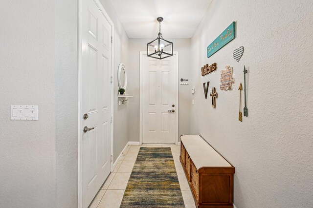 9425 SW Purple Martin Way, Stuart, FL 34997 - doorway with a chandelier, tile patterned flooring, and a textured wall