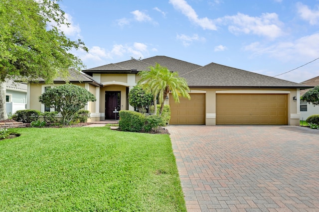 5857 NW Leghorn Ave, Port Saint Lucie, FL 34986 - view of front of house with stucco siding, a garage, decorative driveway, and a front yard