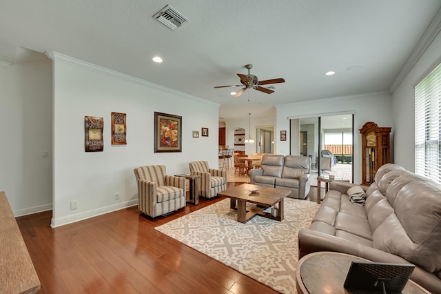 5857 NW Leghorn Ave, Port Saint Lucie, FL 34986 - living room with ceiling fan, crown molding, wood finished floors, and recessed lighting