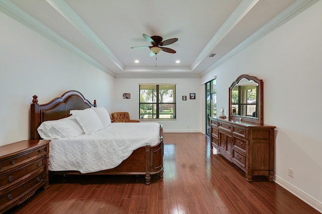 5857 NW Leghorn Ave, Port Saint Lucie, FL 34986 - bedroom with a tray ceiling, dark wood-type flooring, crown molding, and recessed lighting