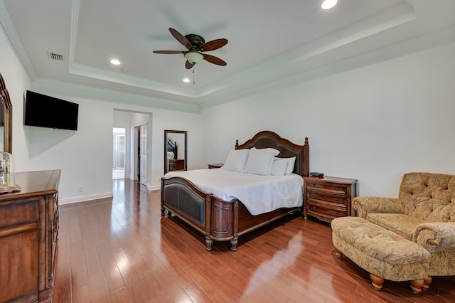 5857 NW Leghorn Ave, Port Saint Lucie, FL 34986 - bedroom featuring a tray ceiling, wood finished floors, recessed lighting, crown molding, and a ceiling fan