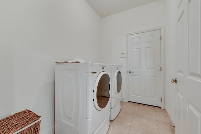5857 NW Leghorn Ave, Port Saint Lucie, FL 34986 - laundry room featuring washer and clothes dryer and light tile patterned flooring
