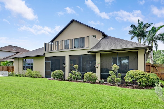 5857 NW Leghorn Ave, Port Saint Lucie, FL 34986 - back of property featuring a balcony, stucco siding, roof with shingles, and a sunroom