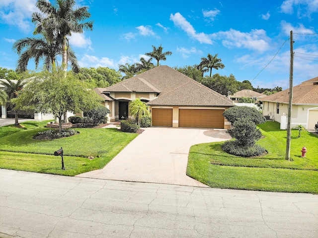 5857 NW Leghorn Ave, Port Saint Lucie, FL 34986 - view of front of property featuring a garage, driveway, a front yard, and stucco siding