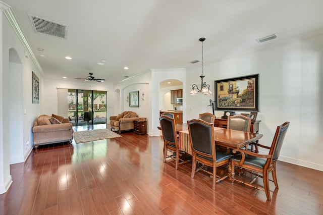 5857 NW Leghorn Ave, Port Saint Lucie, FL 34986 - dining area with arched walkways, ornamental molding, wood finished floors, recessed lighting, and ceiling fan