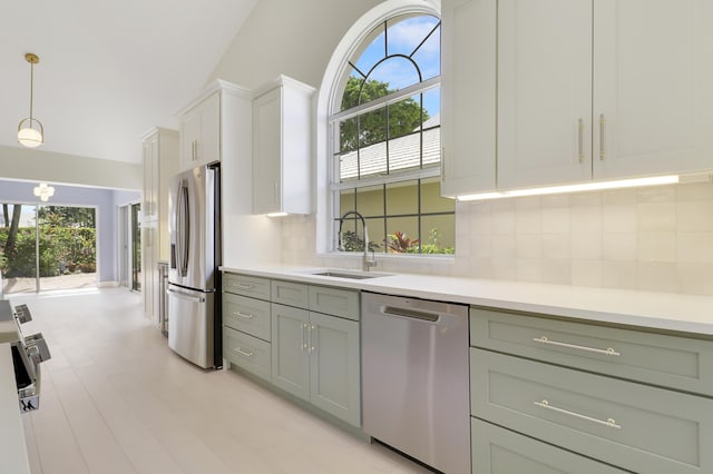 1365 Wilderness Rd, West Palm Beach, FL 33409 - kitchen featuring stainless steel appliances, plenty of natural light, backsplash, and light countertops