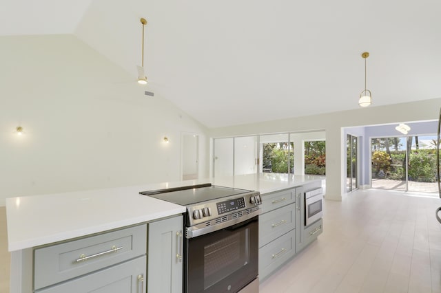 1365 Wilderness Rd, West Palm Beach, FL 33409 - kitchen featuring stainless steel range with electric stovetop, gray cabinetry, lofted ceiling, light countertops, and decorative light fixtures