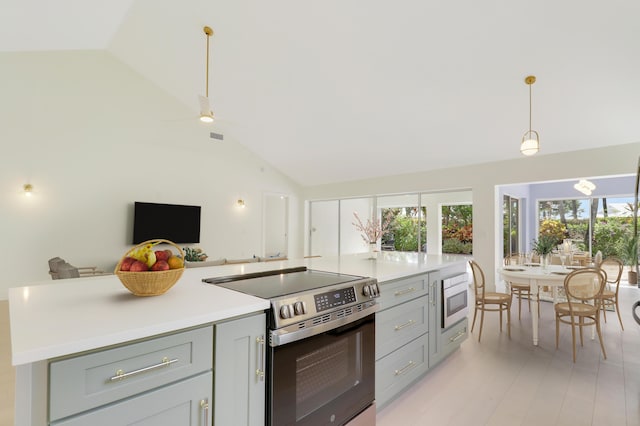 1365 Wilderness Rd, West Palm Beach, FL 33409 - kitchen with appliances with stainless steel finishes, gray cabinetry, lofted ceiling, open floor plan, and light countertops