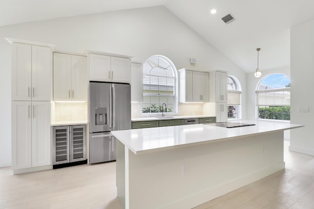 1365 Wilderness Rd, West Palm Beach, FL 33409 - kitchen with stainless steel refrigerator with ice dispenser, beverage cooler, high vaulted ceiling, light countertops, and tasteful backsplash
