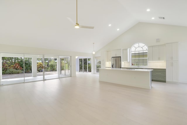 1365 Wilderness Rd, West Palm Beach, FL 33409 - unfurnished living room with high vaulted ceiling, a ceiling fan, light wood finished floors, and recessed lighting