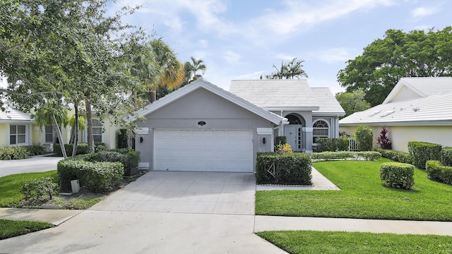 1365 Wilderness Rd, West Palm Beach, FL 33409 - single story home with an attached garage, a front lawn, driveway, and stucco siding