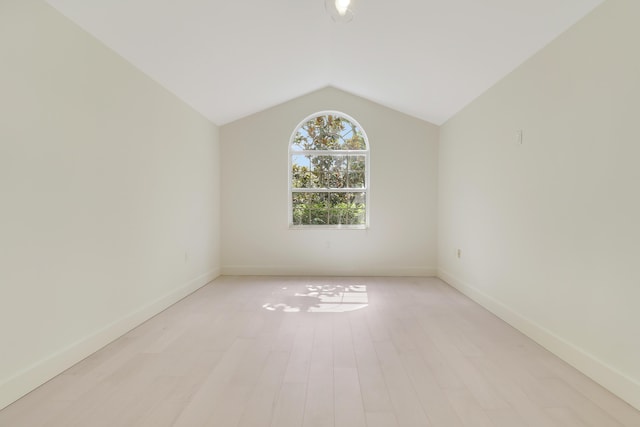 1365 Wilderness Rd, West Palm Beach, FL 33409 - empty room with light wood-style floors and vaulted ceiling