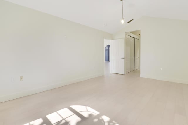 1365 Wilderness Rd, West Palm Beach, FL 33409 - unfurnished room featuring lofted ceiling and light wood-style flooring