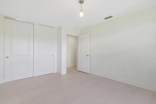1365 Wilderness Rd, West Palm Beach, FL 33409 - unfurnished bedroom with light wood-type flooring and a closet
