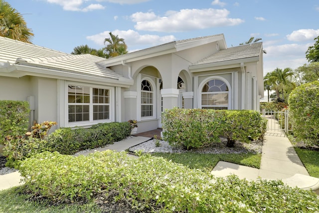 1365 Wilderness Rd, West Palm Beach, FL 33409 - view of front facade with a tiled roof and stucco siding