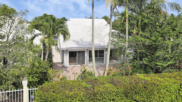 1365 Wilderness Rd, West Palm Beach, FL 33409 - view of side of property featuring a sunroom