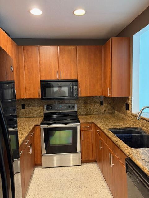 1377 Via De Pepi, Boynton Beach, FL 33426 - kitchen with stainless steel appliances, a sink, light stone countertops, backsplash, and brown cabinets