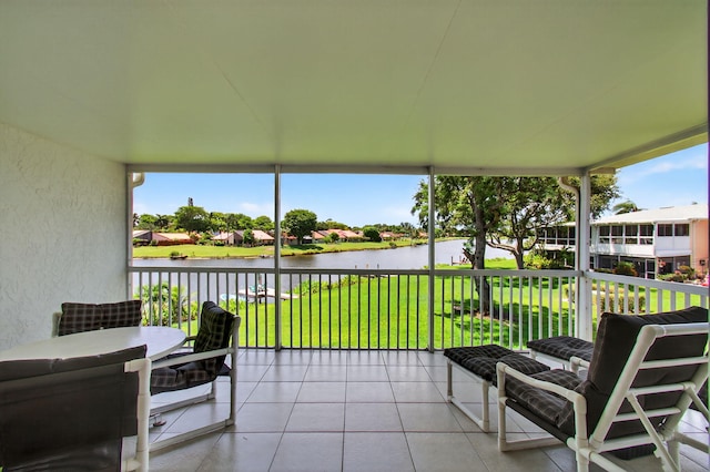 1320 NW 20th Ave Unit 202, Delray Beach, FL 33445 - sunroom / solarium with a water view, a textured wall, and tile patterned flooring